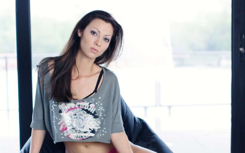 woman in crop top by window