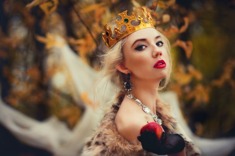 Woman in Crown Holding Apple
