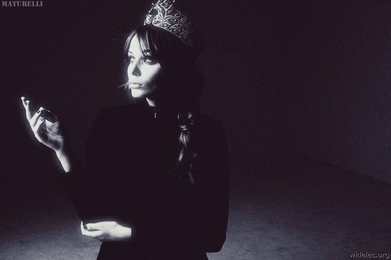 woman in crown with hand gesture