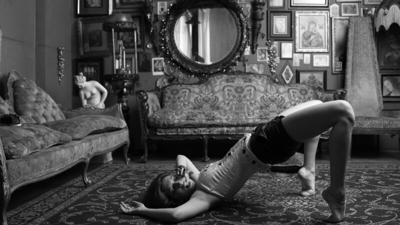 woman in dance pose on floor