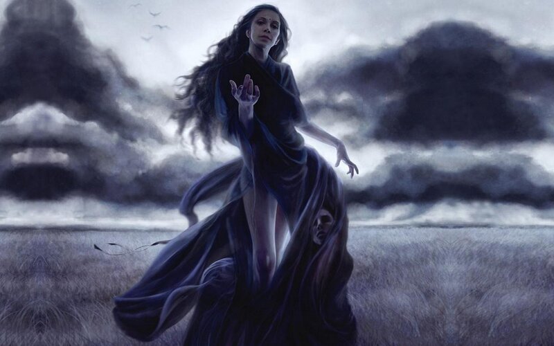 Woman in dark cloak on a stormy plain