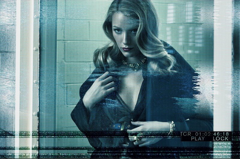 woman in dark coat behind glass