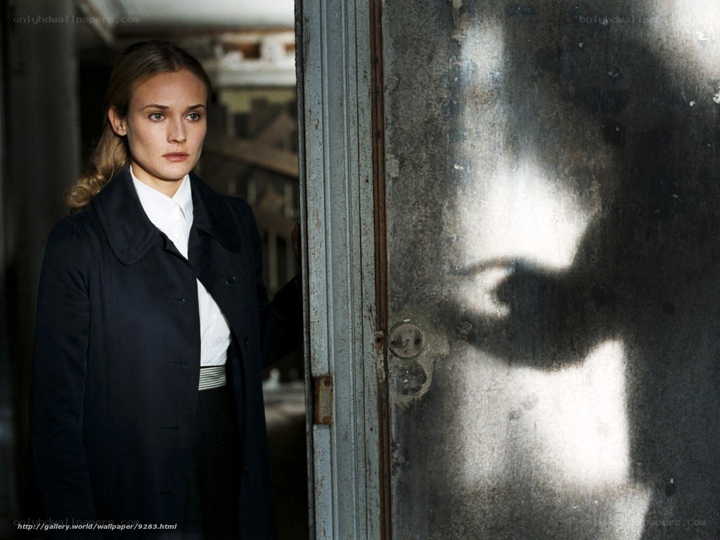 woman in dark coat standing in doorway