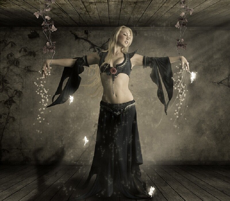 woman in dark costume with sparkles