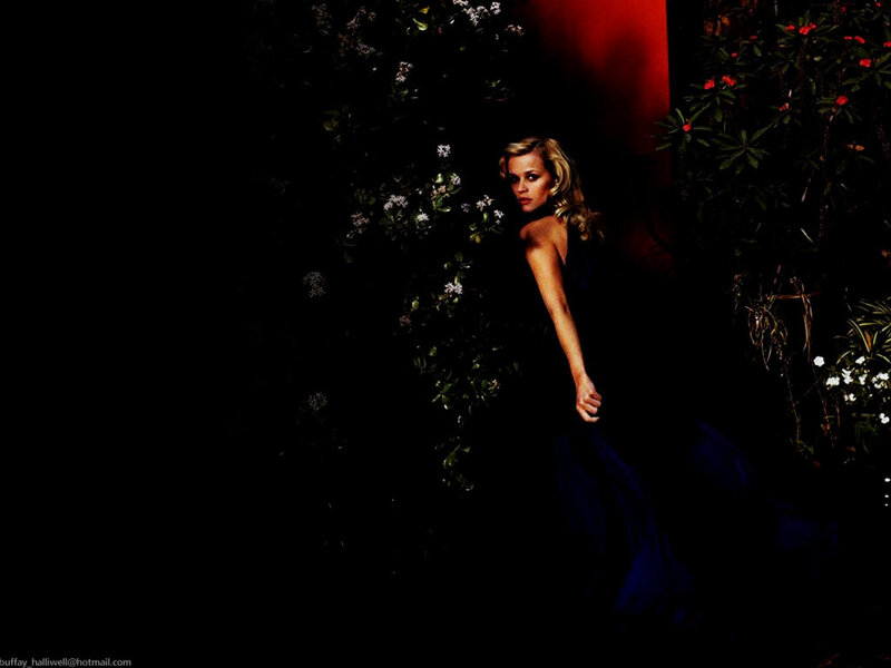 woman in dark dress among flowers