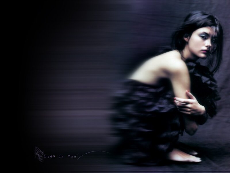 woman in dark dress looking at camera