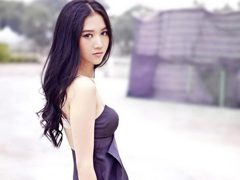 woman in dark dress looking back