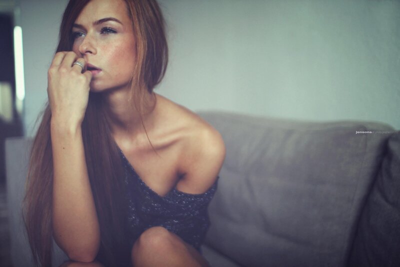 woman in dark dress on couch