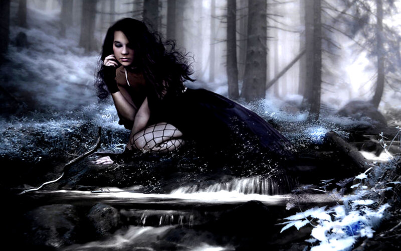 woman in dark forest stream