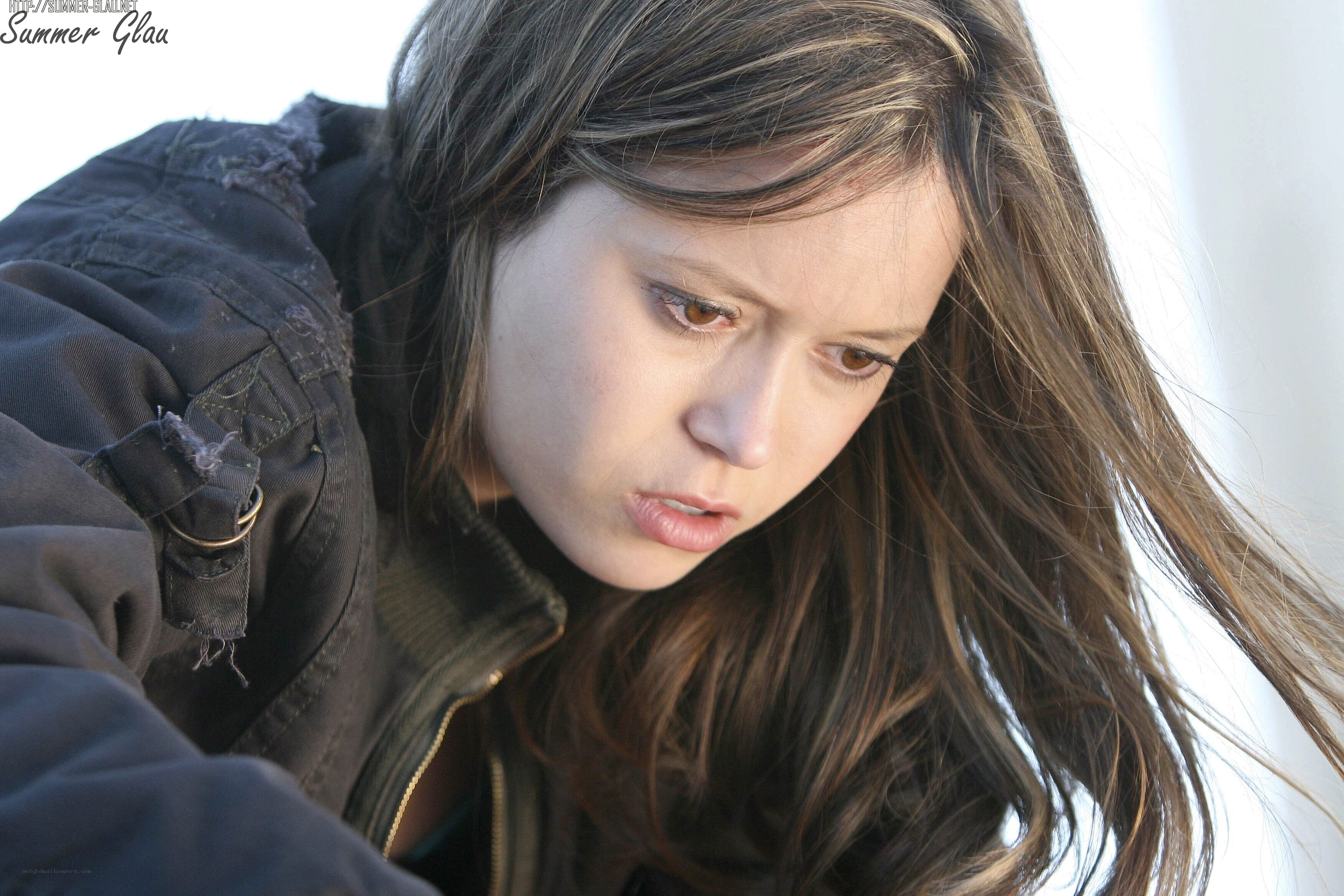 woman in dark jacket looking down