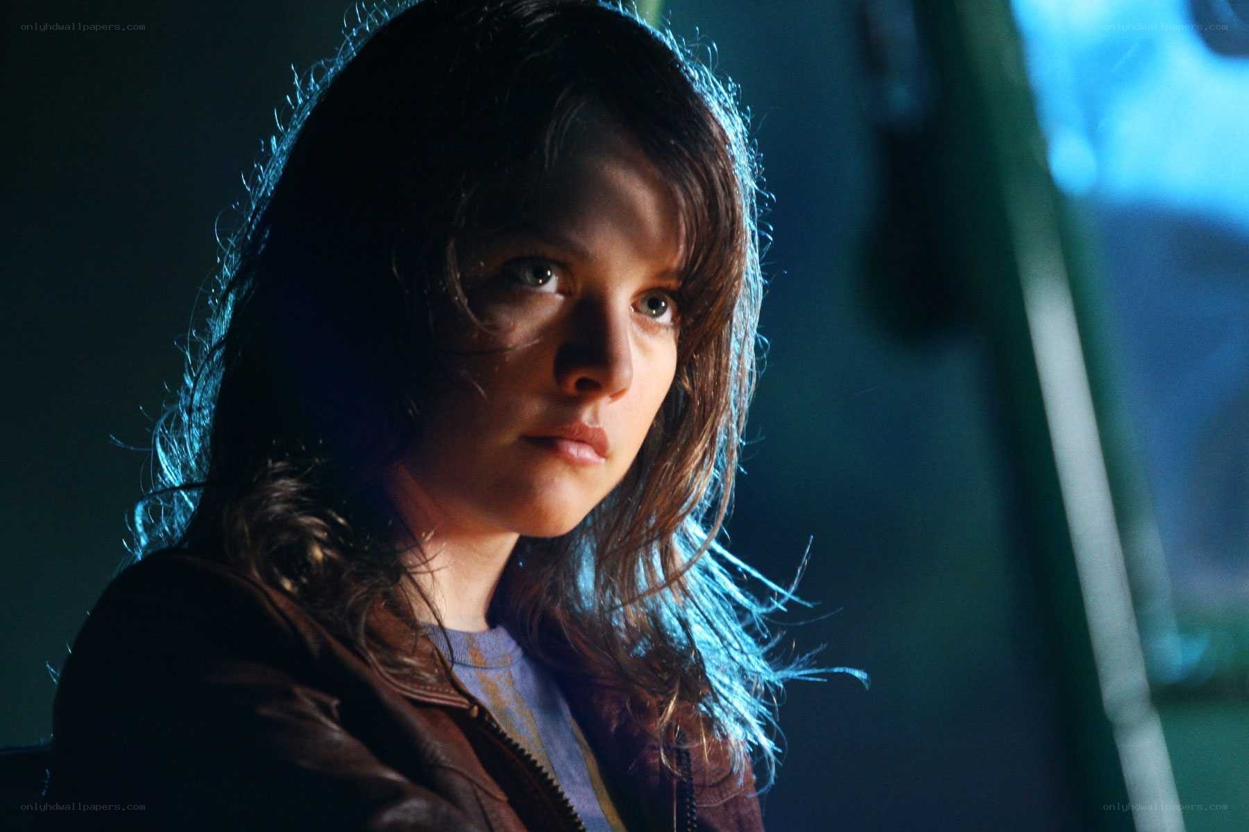 woman in dark jacket looking forward