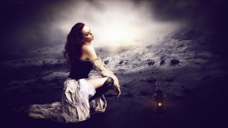 woman in dark landscape with lantern