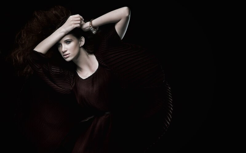 woman in dark pleated dress