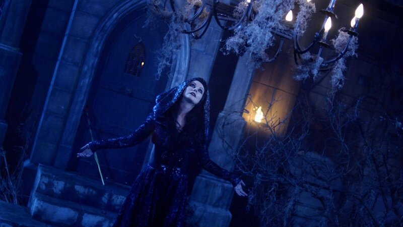 woman in dark robe on steps