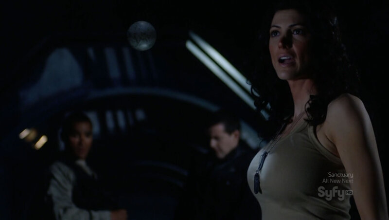 woman in dark room with floating orb