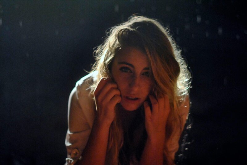 woman in dark room with rain