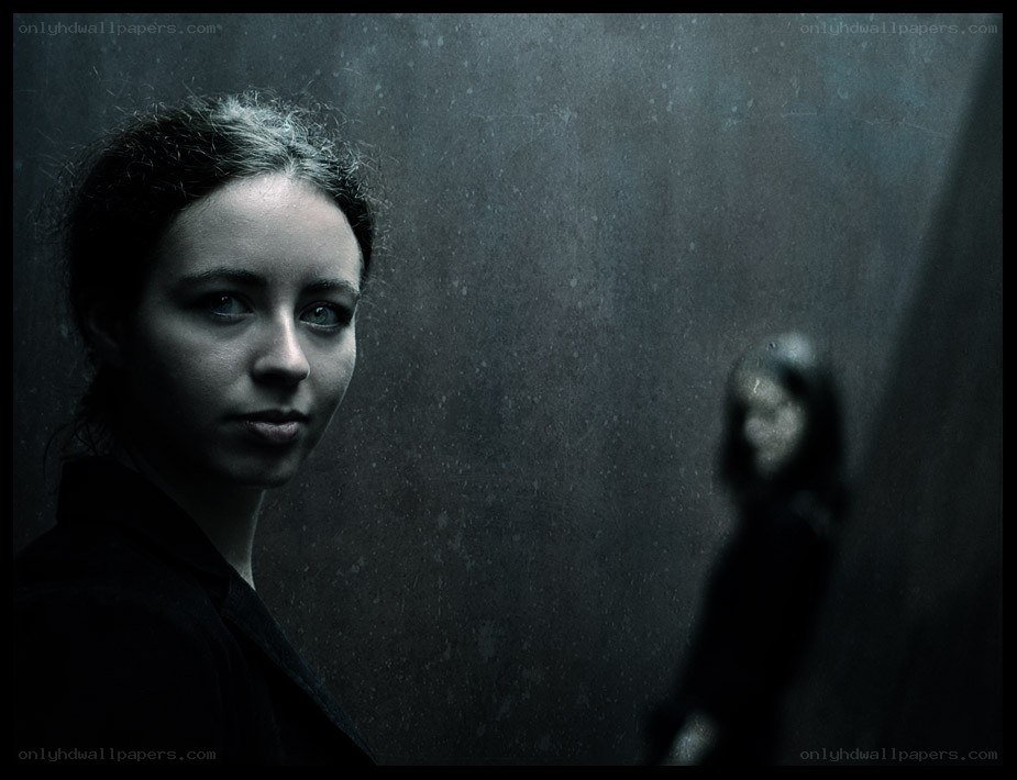 woman in dark room with reflection