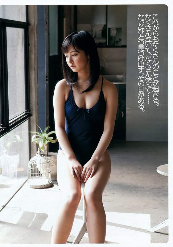 woman in dark swimsuit sitting