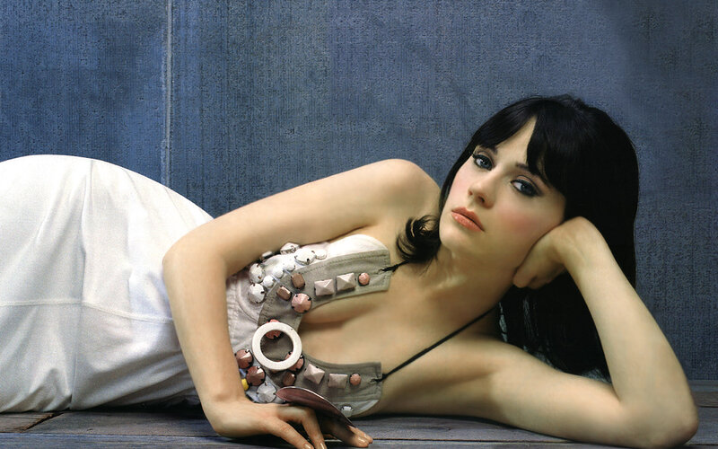 woman in decorative top lying down