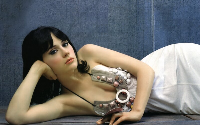 woman in decorative top lying down