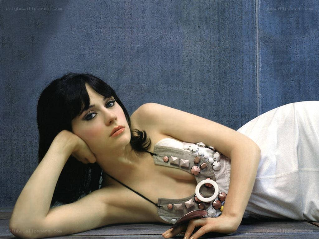woman in decorative top lying down