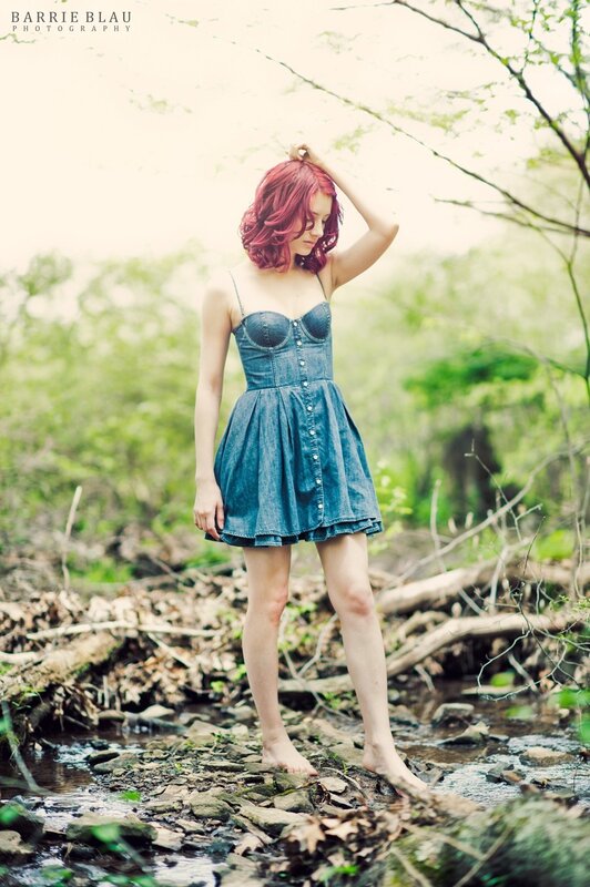 Woman in denim dress by stream