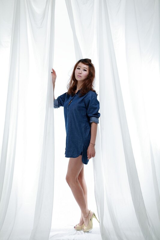 Woman in Denim Dress — White, Serene, Photograph