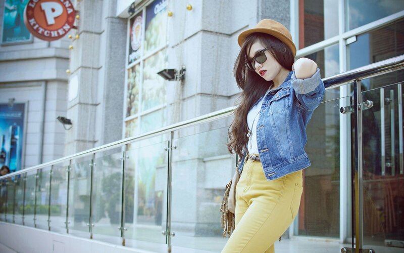 woman in denim jacket and yellow pants