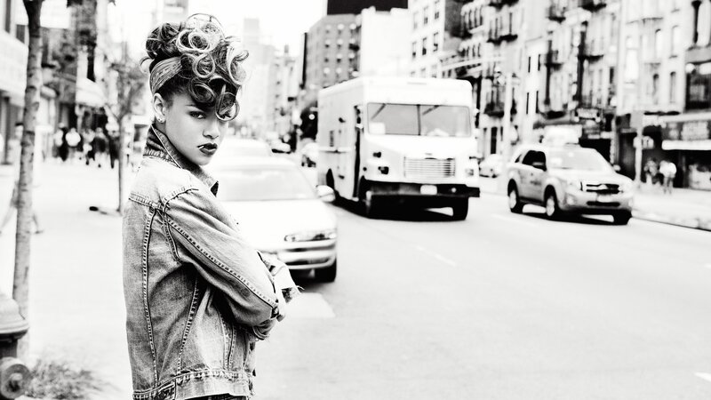 woman in denim jacket on city street