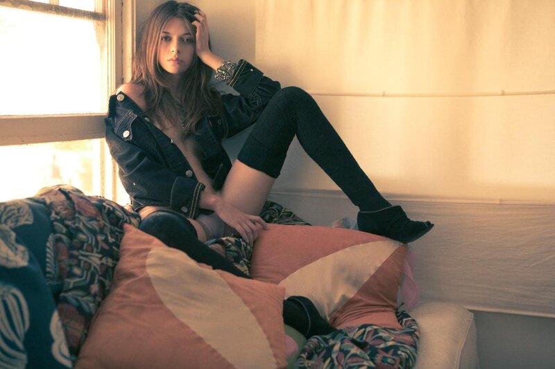 woman in denim jacket on couch