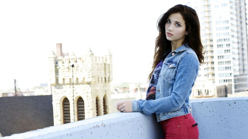 woman in denim jacket on rooftop