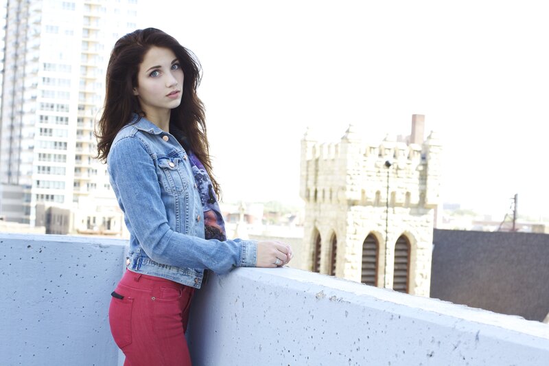 woman in denim jacket on rooftop