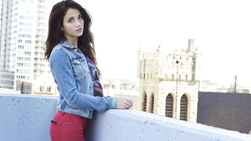 woman in denim jacket on rooftop