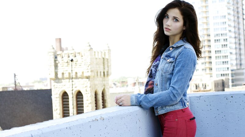 woman in denim jacket on rooftop