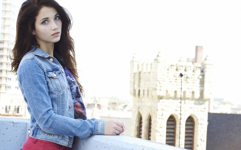 woman in denim jacket on rooftop