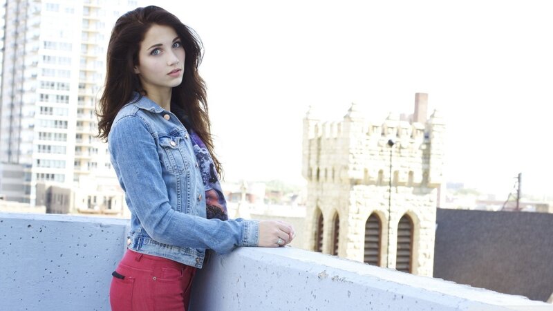 woman in denim jacket on rooftop