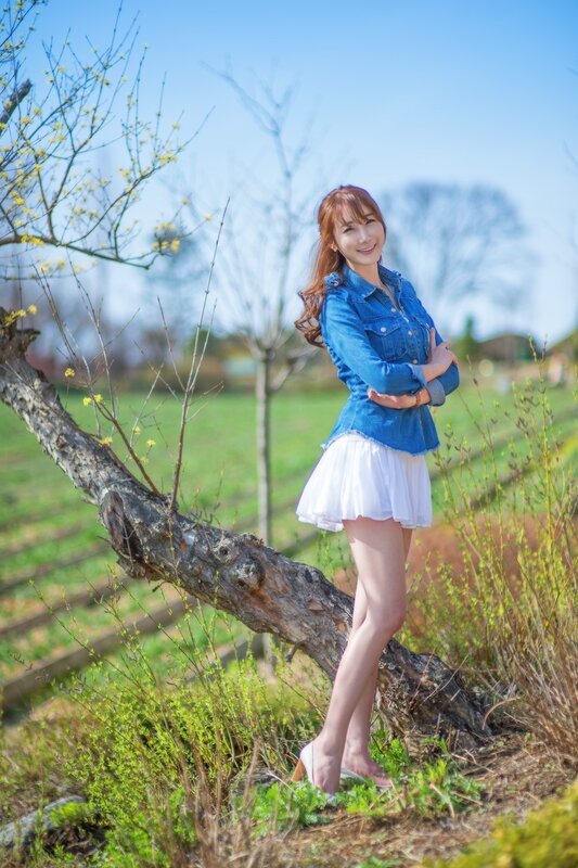 Woman in denim jacket outdoors
