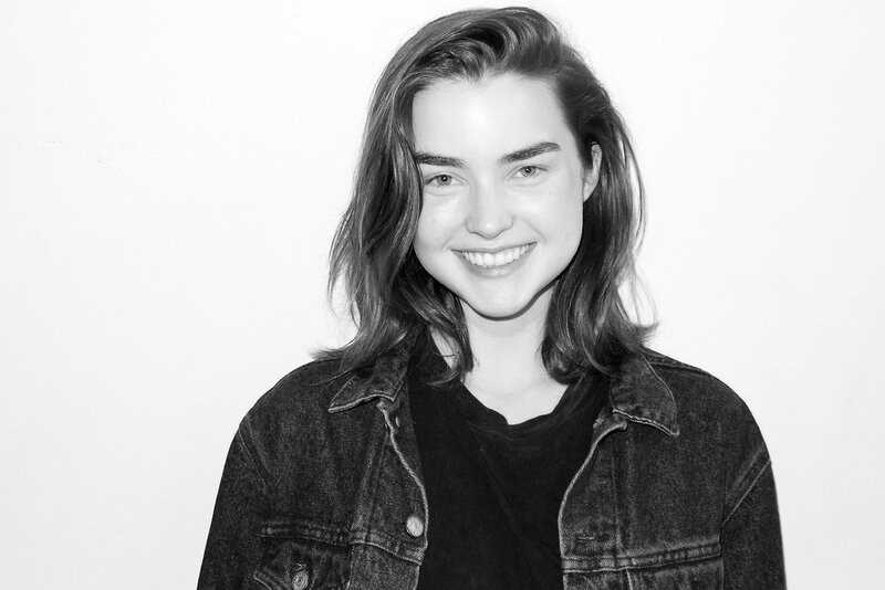 woman in denim jacket smiling