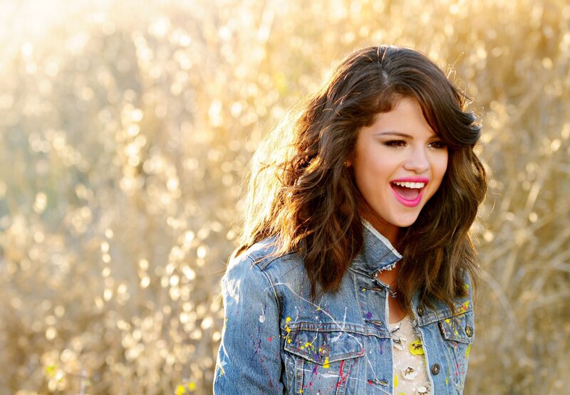 woman in denim jacket smiling