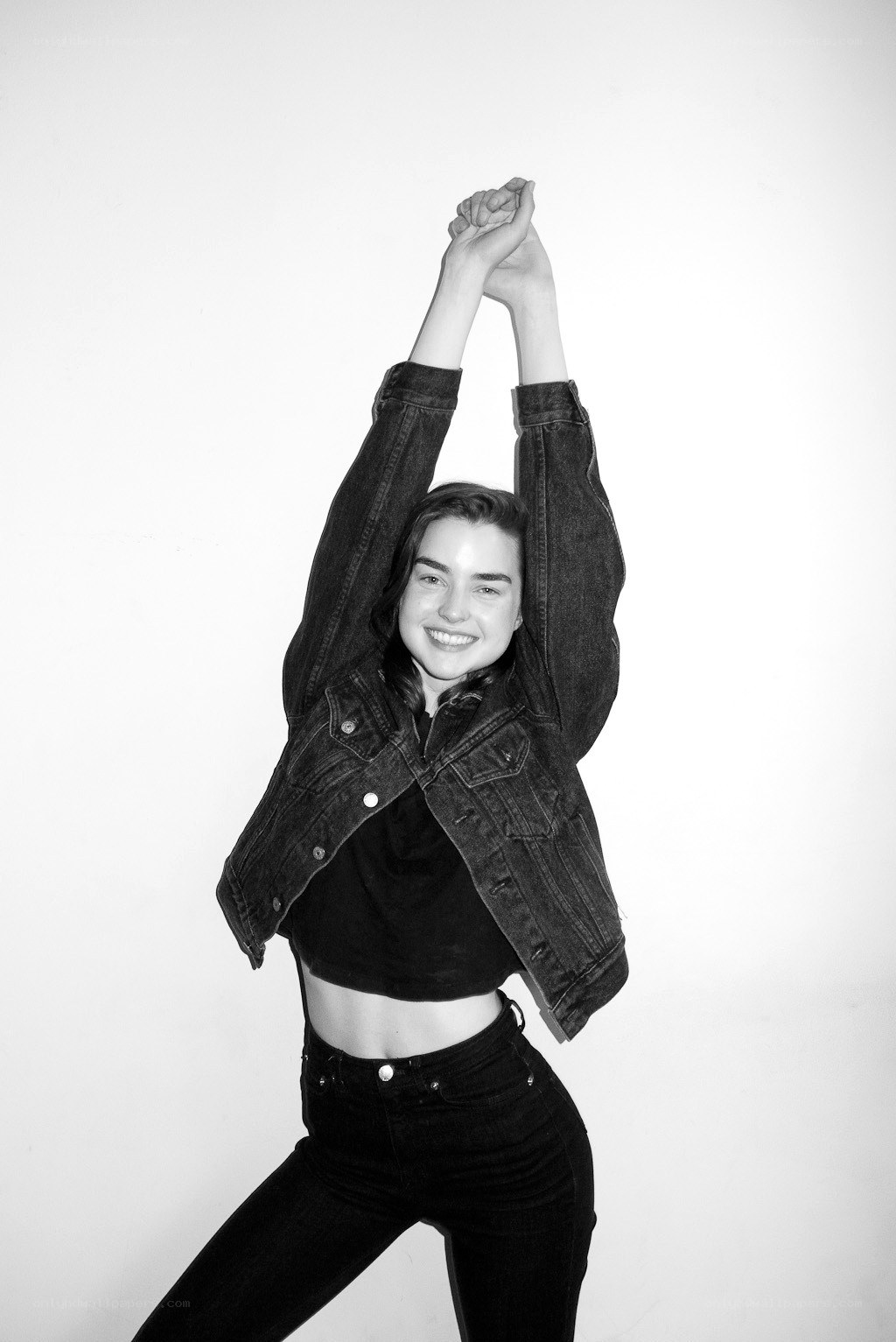 woman in denim jacket stretching