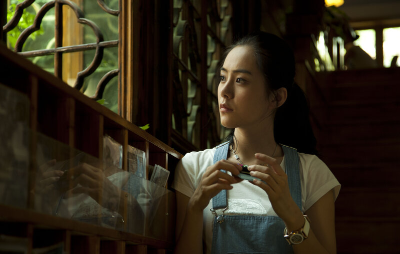 Woman in Denim Overalls — Brown, Contemplative