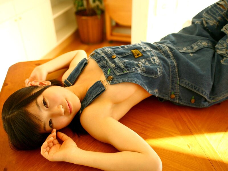 woman in denim overalls lying down