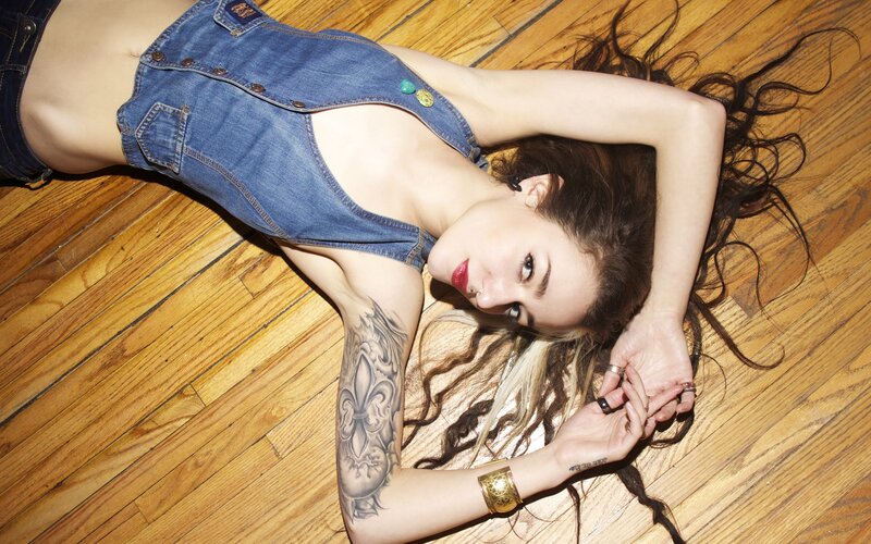 woman in denim overalls lying on floor