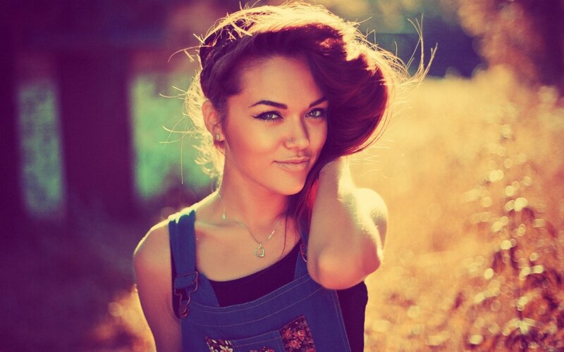 woman in denim overalls outdoors
