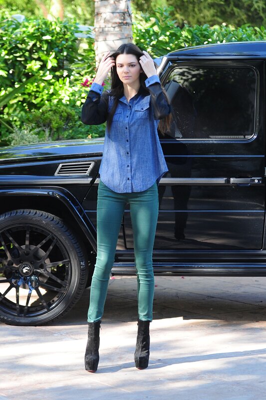 woman in denim shirt and green pants