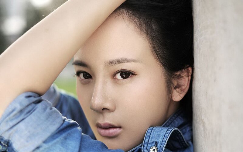 woman in denim shirt leaning