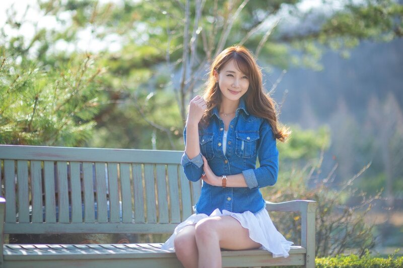 Woman in denim shirt on bench