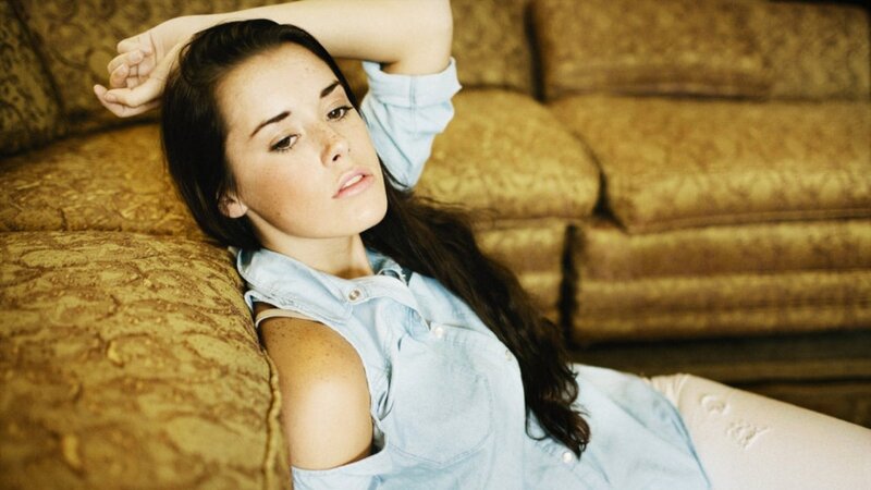 woman in denim shirt on couch