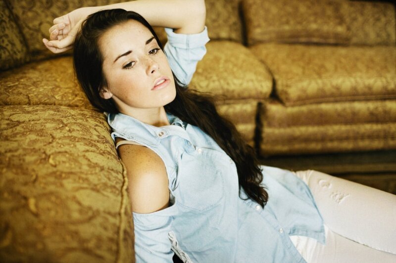 woman in denim shirt on couch