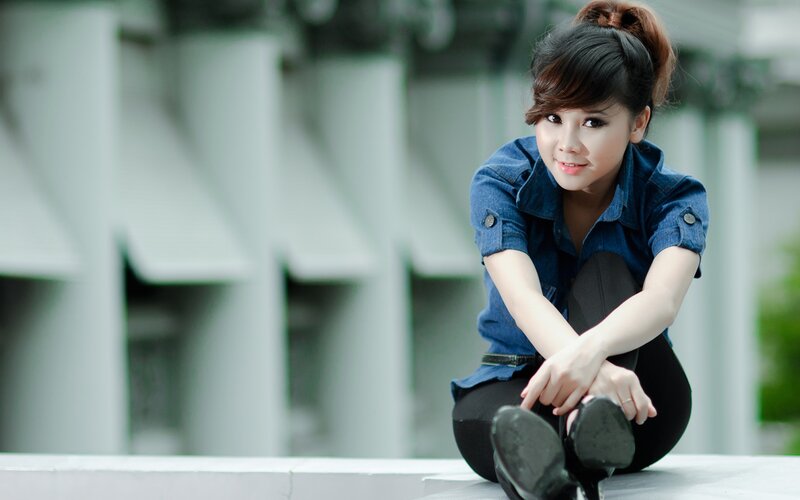 woman in denim shirt sitting